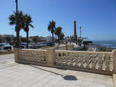 a white fence on a sidewalk near the ocean at Penthouse on the Costa de la Luz, Air conditioning, beach 300 meters away in Chipiona
