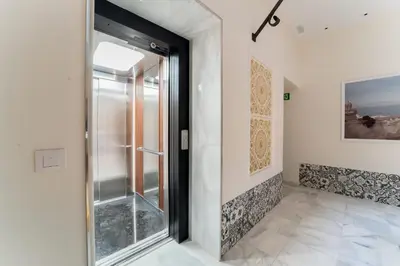 a glass door in a room with a tile floor at Suite Capitán 1 in Cádiz