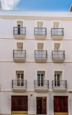 a facade of a white building with balconies at Suite Capitán 2 in Cádiz