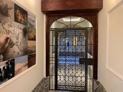 a glass door in a hallway with pictures on the wall at Apartamento Entrecatedrales 2 in Cádiz