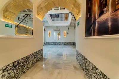 a hallway with arched ceilings and tile floors at Cádiz desde el balcón in Cádiz