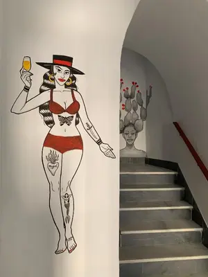 a mural of a woman holding a glass of wine at Casa Miguel - Apartamento 4 in Sanlúcar de Barrameda