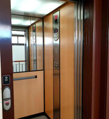 a row of wooden elevators in a building at Sherryflat Neira - Parking in Jerez de la Frontera