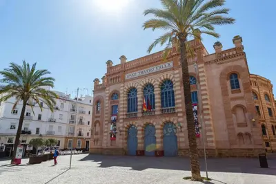 a large building with palm trees in front of it at Apartamento El SEMINARISTA by Cadiz4Rentals in Cádiz