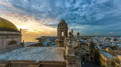 a view of a city with a clock tower at La Galería de Botica in Cádiz
