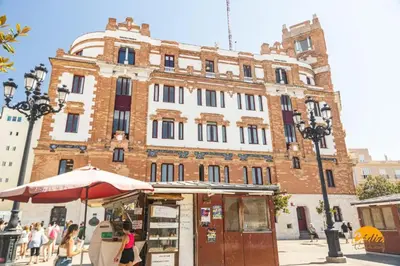 a building with an umbrella in front of it at Tailor's Home by Cadiz Time in Cádiz
