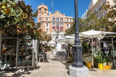 a street with tables and umbrellas and a building at Tailor's Home by Cadiz Time in Cádiz