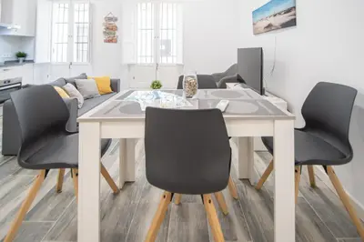 a dining room with a table and chairs at Estudio Al Sur de Cádiz in Cádiz