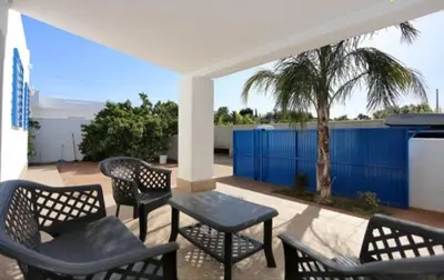 a group of chairs and tables on a patio at Casa Juani in Conil de la Frontera