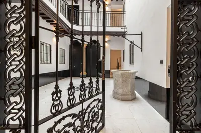 an open iron gate in a hallway with a staircase at Allo Apartments San Roque Bajo C in Cádiz