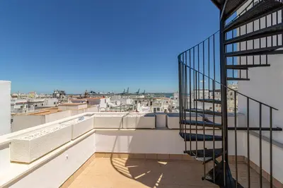 a balcony with a spiral staircase on a building at Allo Apartments San Roque 2ºC in Cádiz