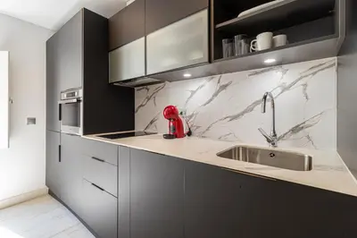 a kitchen with a sink and a red appliance on the counter at Allo Apartments San Roque 3ºB in Cádiz