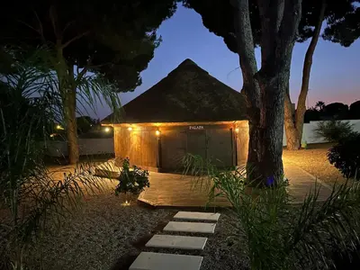 a small tent with lights in a yard at night at CÁDIZ - BUDA, acogedor apartamento en Chiclana de la Frontera, España in Chiclana de la Frontera