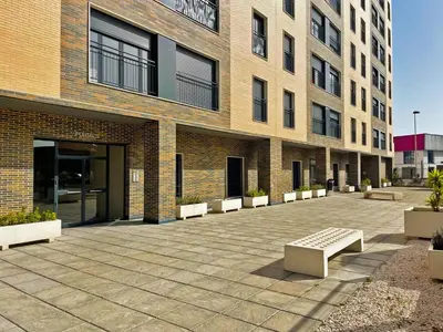 a brick building with benches in front of it at Apartamento Alazán - Ole Solutions in Jerez de la Frontera