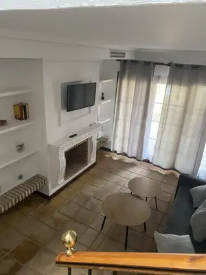 a living room with a couch and a tv at APARTAMENTOS LUZ DE LA BAHÍA SUR CADIZ San Fernando in San Fernando